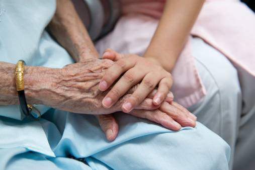 Nurse Comforts Elderly Patient