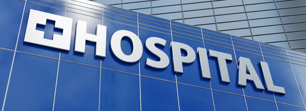 Exterior of a hospital with a sign that says "HOSPITAL"
