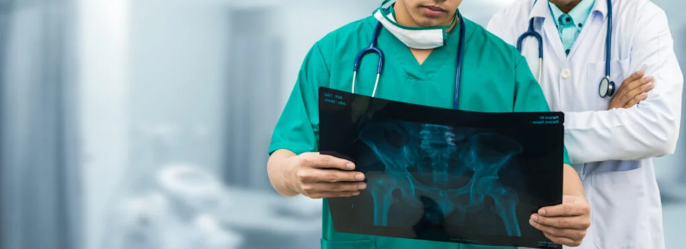 Two doctors examining an Xray of a person's hips